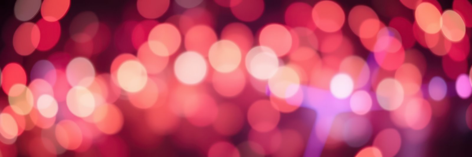 Festive lights create a vibrant atmosphere during a nighttime celebration in the city